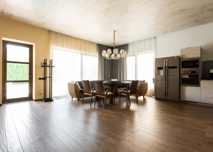 interior view of modern kitchen and dining room with table and chairs