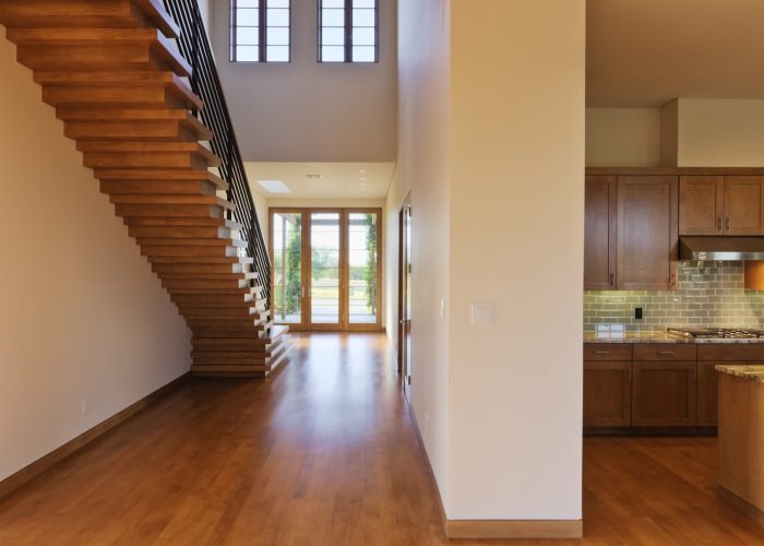 Spacious Hallway Showing a Staircase and Modern Kitchen